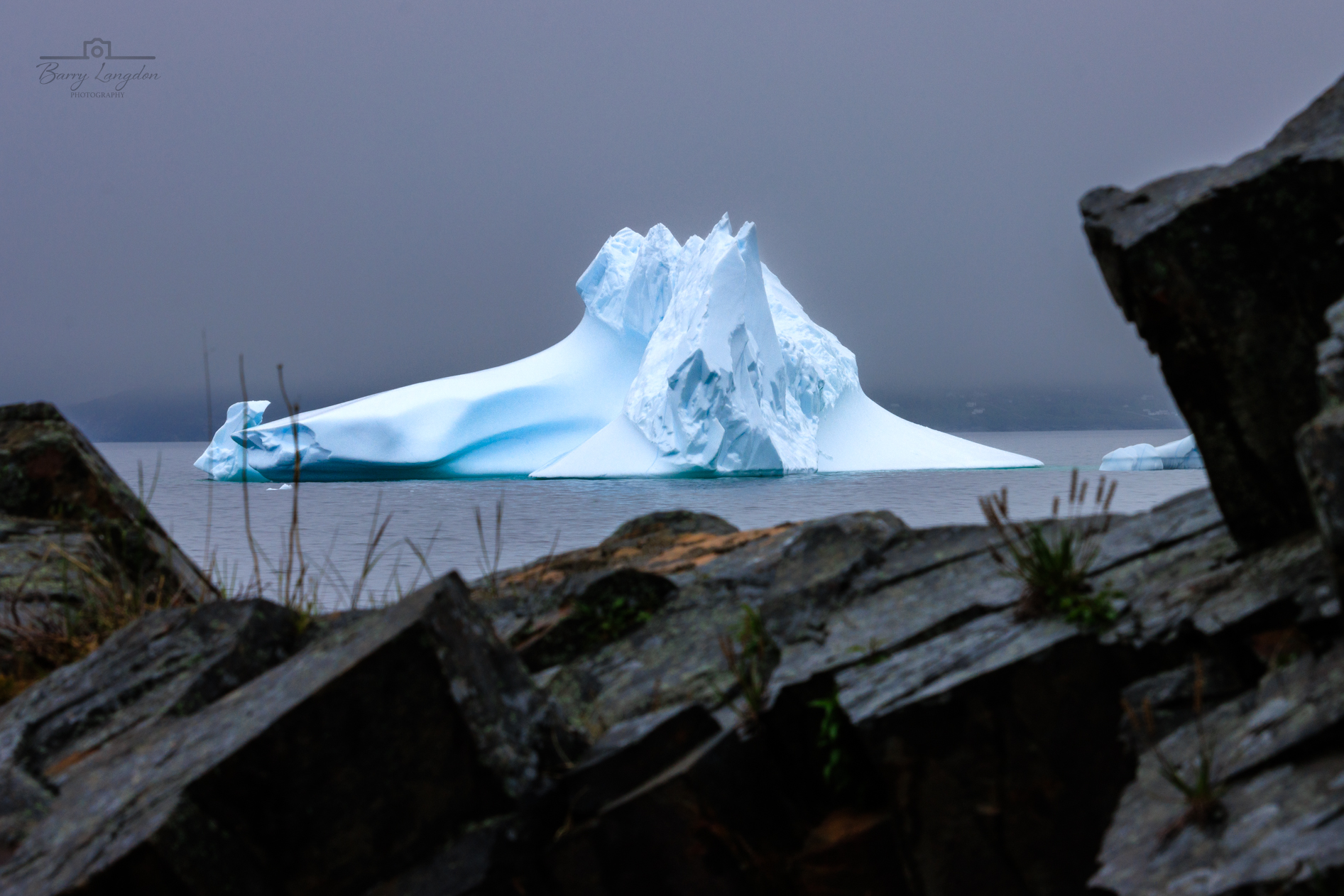 Iceberg With Rocks Iceberg framed in a rock - Downhome Magazine